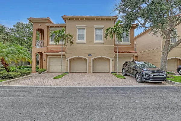 a front view of a house with parking space