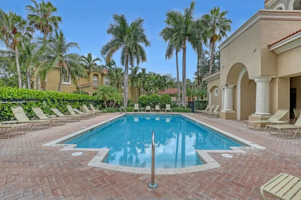 a swimming pool with outdoor seating and yard
