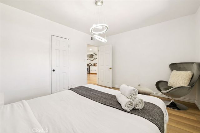 a large bed sitting in a bedroom next to a window