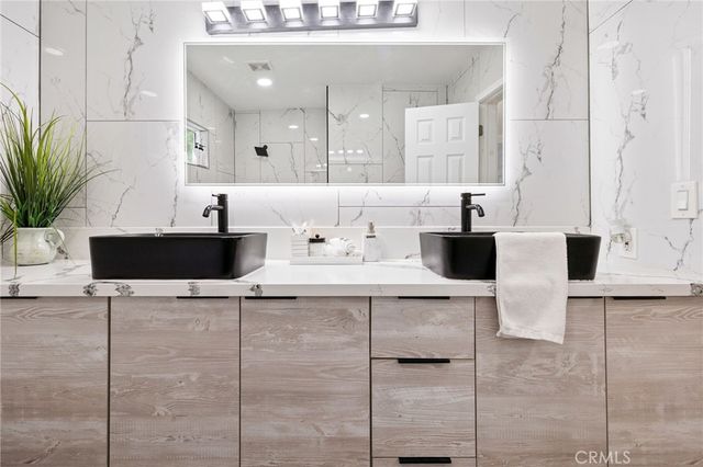 a bathroom with a sink a mirror and a toilet