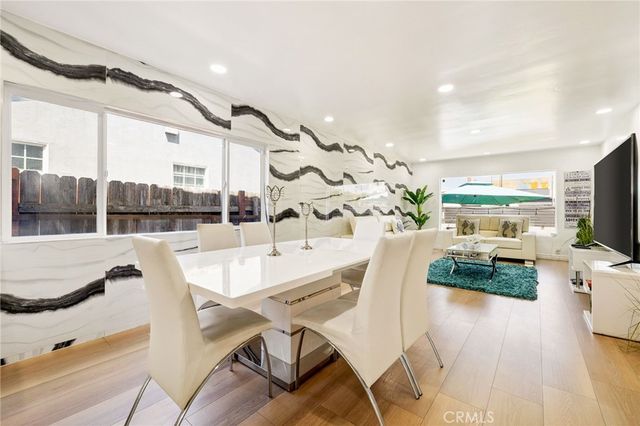 a kitchen with stainless steel appliances kitchen island granite countertop a sink a stove and cabinets