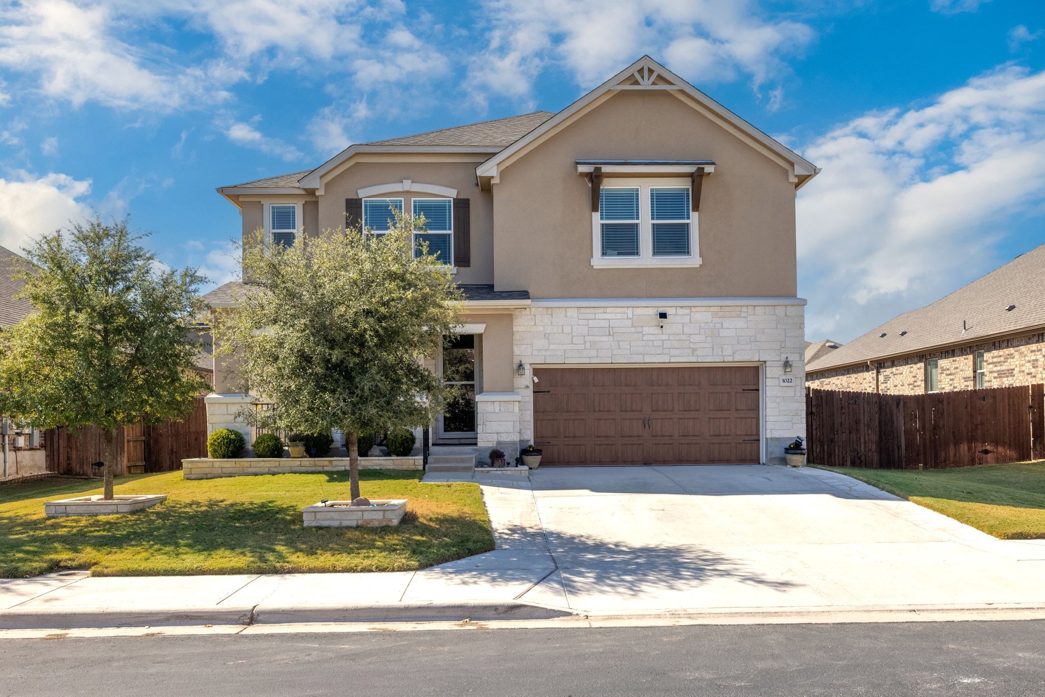 a front view of a house with a yard and garage