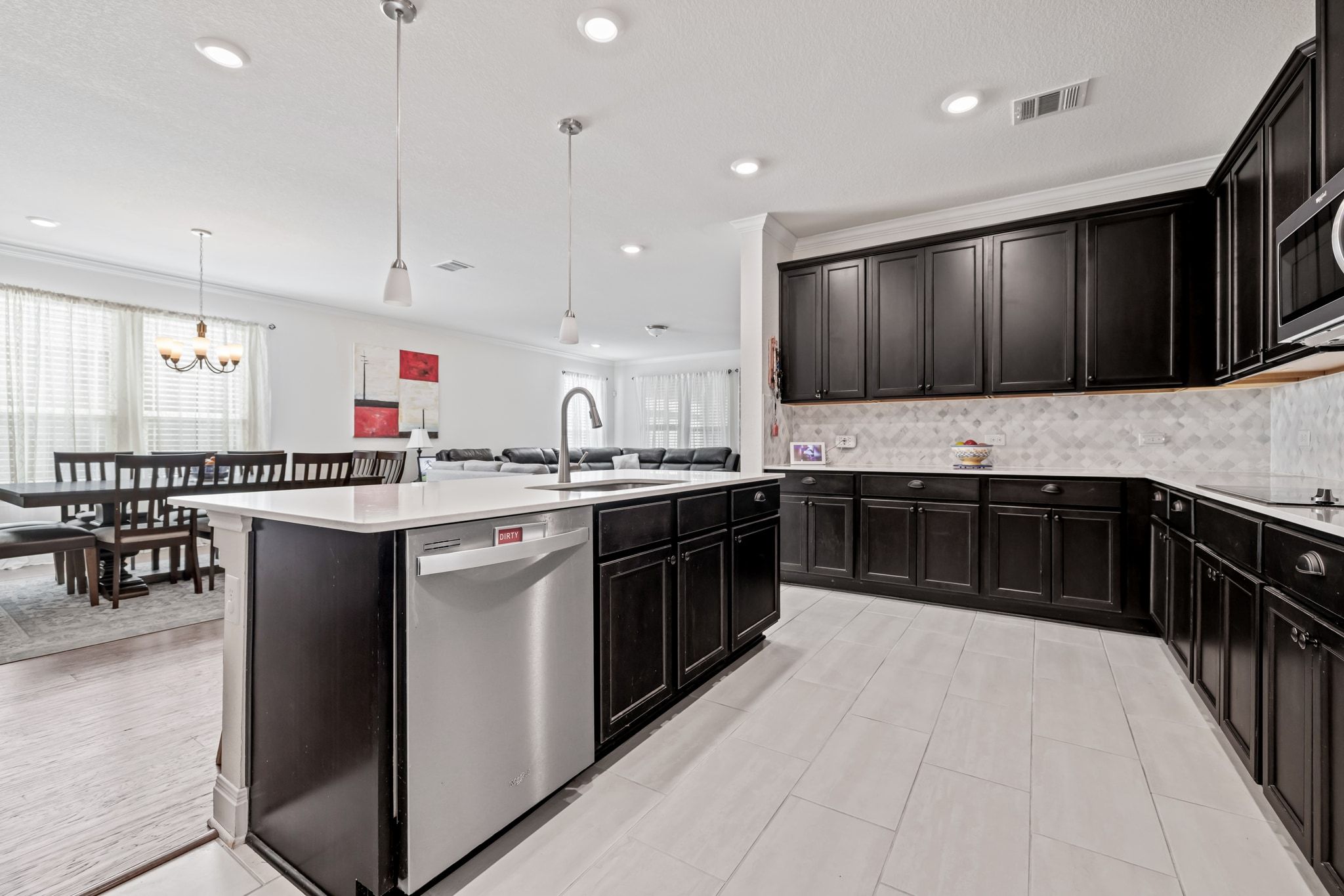 1022 Toltec Trail Georgetown, TX 78626 - Photo 14 of 37 Kitchen featuring ornamental molding, stainless steel appliances, tasteful backsplash, pendant lighting, and a kitchen island with sink