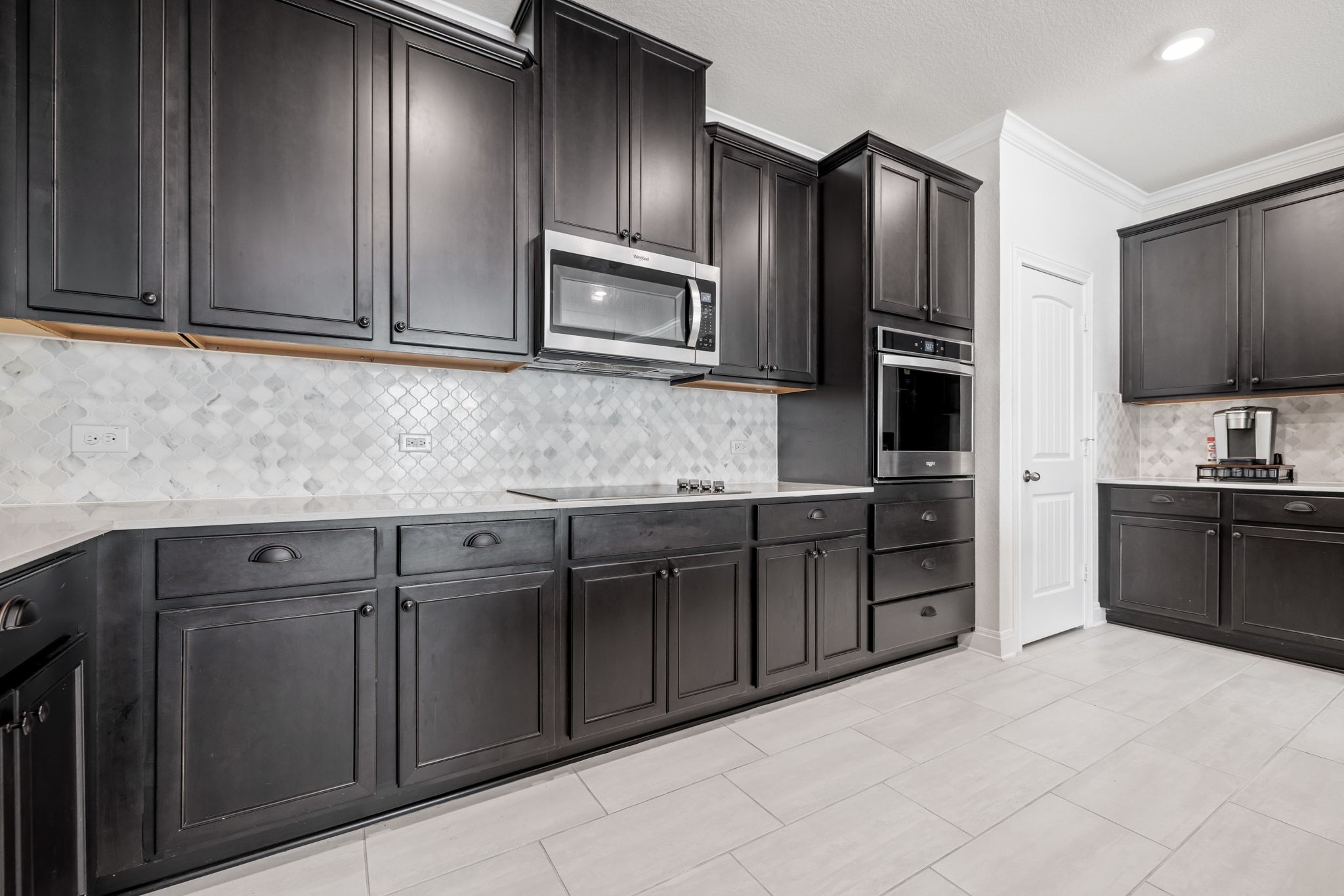 1022 Toltec Trail Georgetown, TX 78626 - Photo 15 of 37 Kitchen featuring tasteful backsplash, crown molding, stainless steel appliances, light stone counters, and light tile patterned flooring