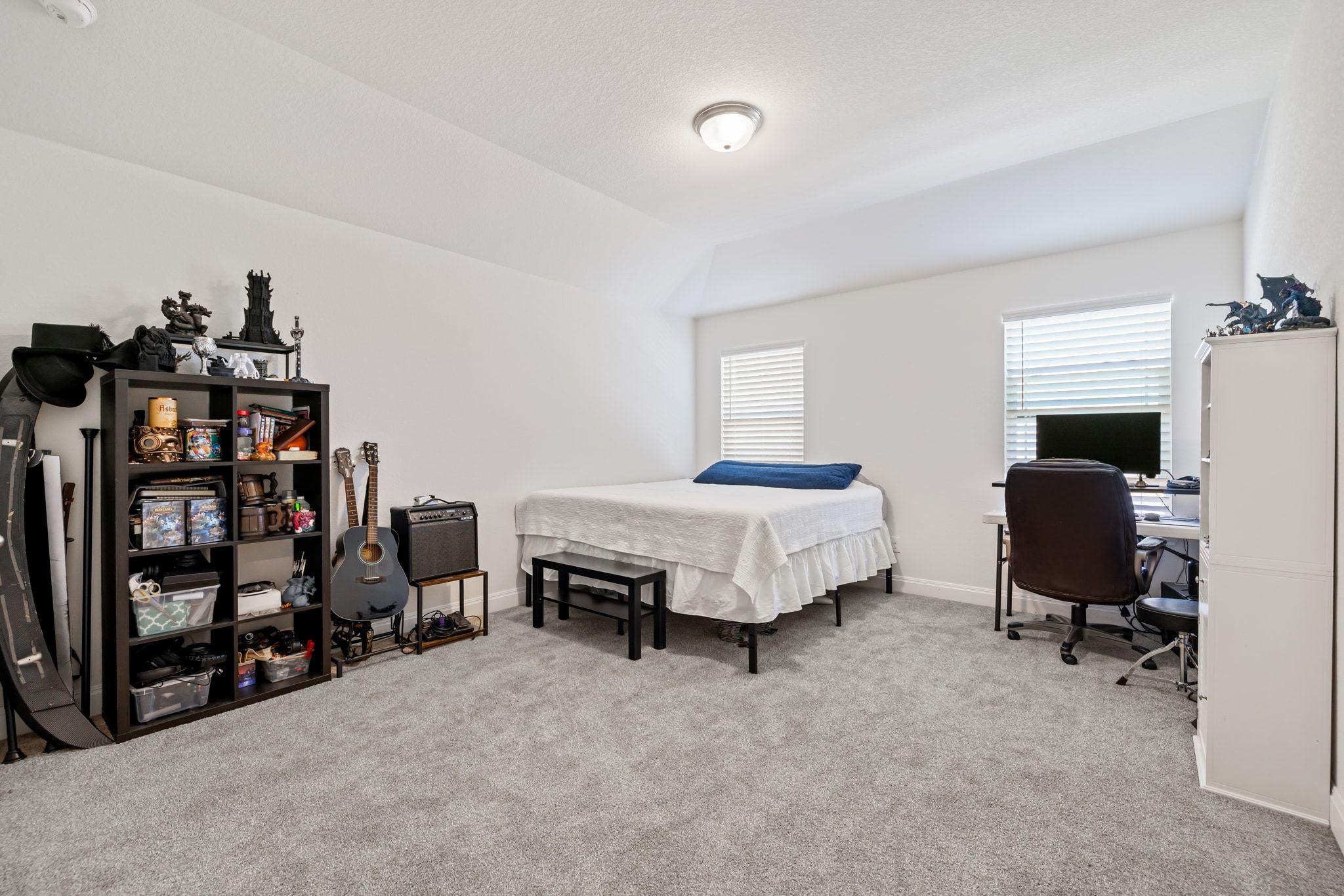 1022 Toltec Trail Georgetown, TX 78626 - Photo 23 of 37 Bedroom with light colored carpet, an office area, and lofted ceiling
