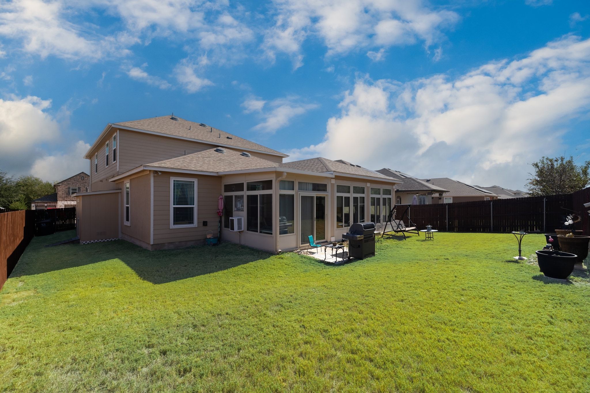1022 Toltec Trail Georgetown, TX 78626 - Photo 35 of 37 Back of house featuring a fenced backyard, a sunroom, a patio, and a shingled roof
