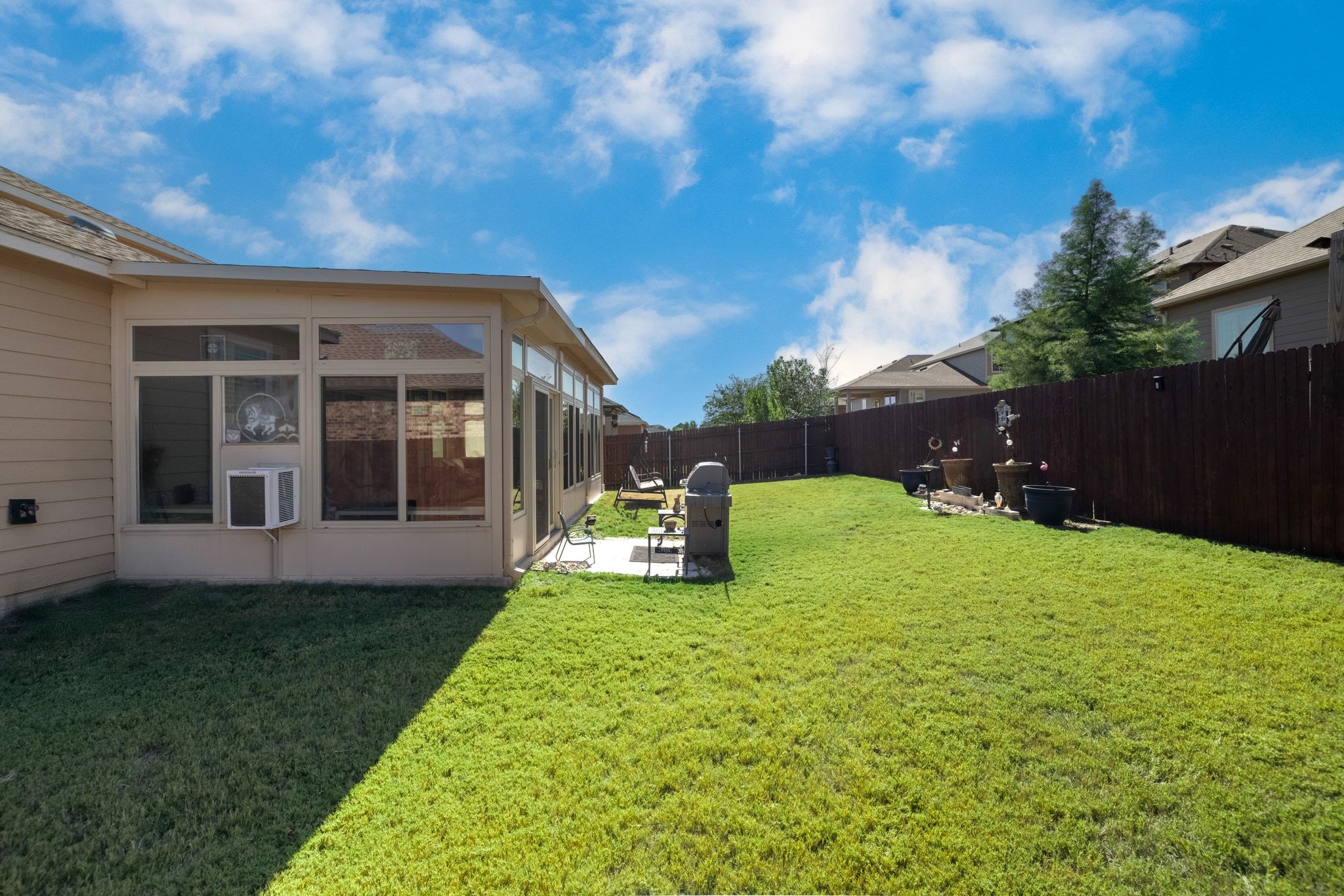 1022 Toltec Trail Georgetown, TX 78626 - Photo 36 of 37 Fenced backyard featuring a sunroom, a patio area, and cooling unit