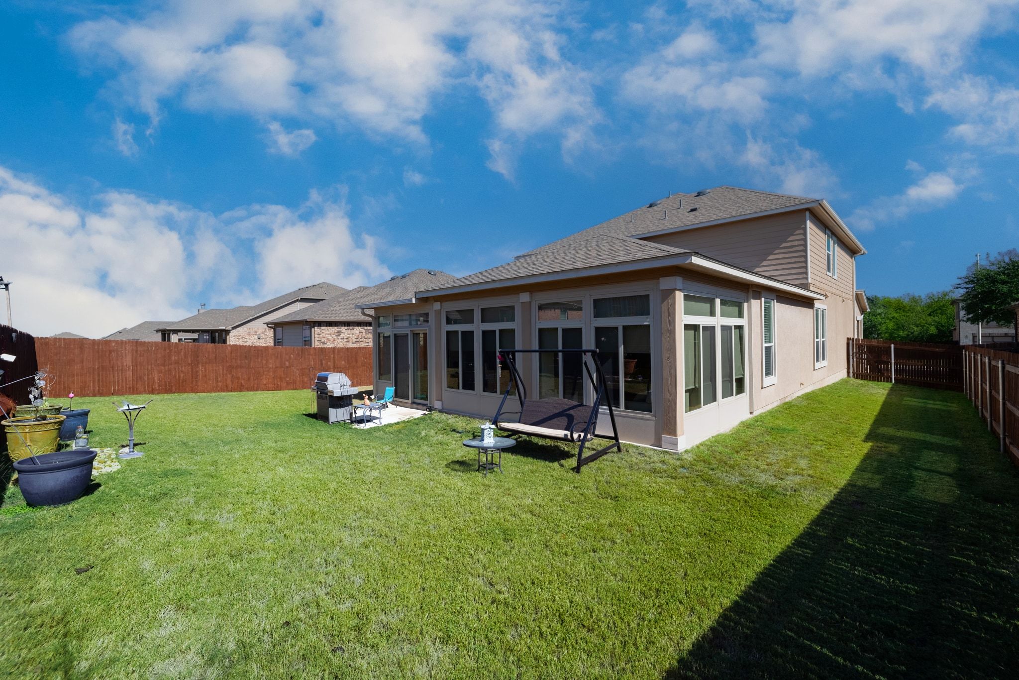 1022 Toltec Trail Georgetown, TX 78626 - Photo 37 of 37 Rear view of house with a sunroom, a fenced backyard, and a shingled roof