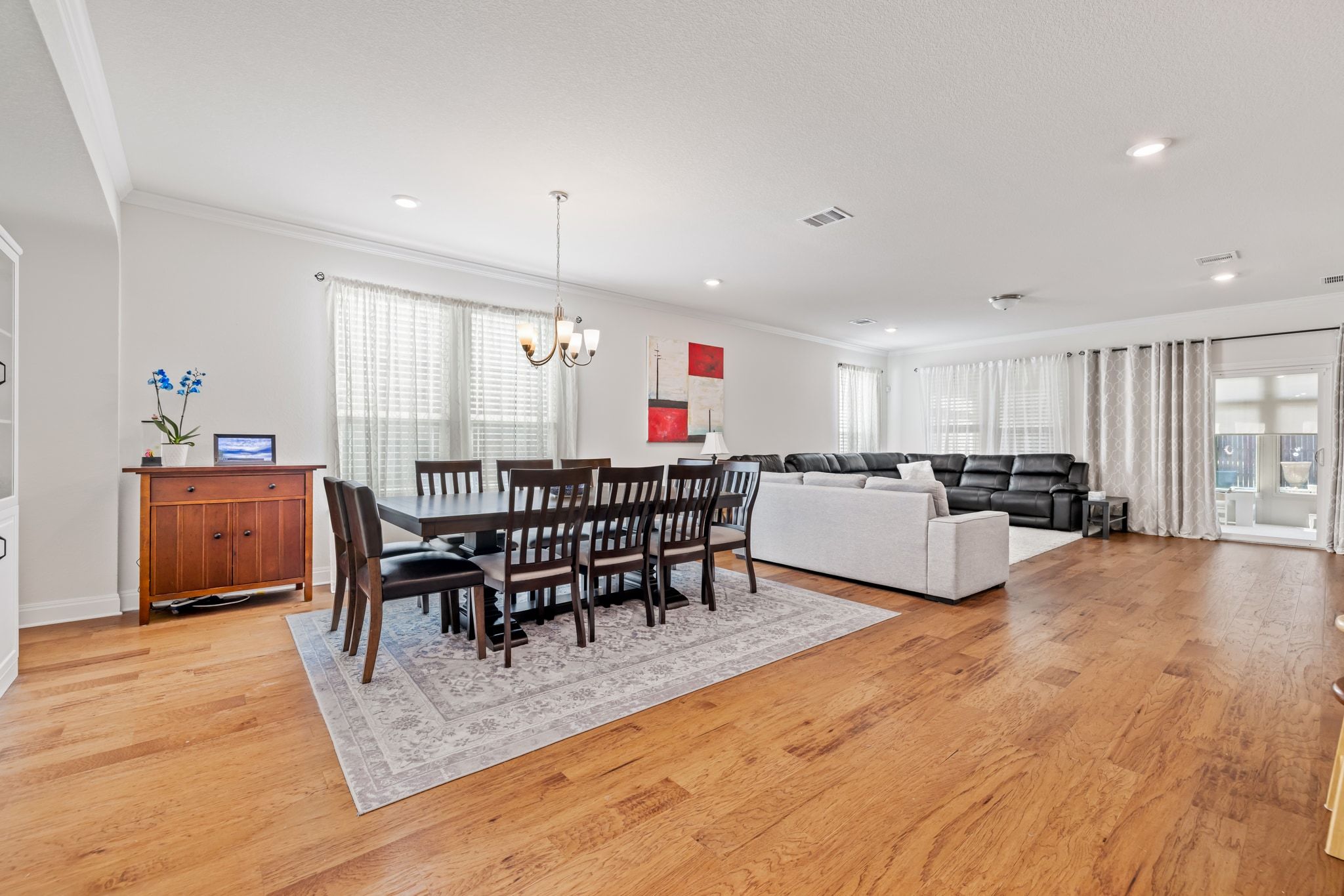 1022 Toltec Trail Georgetown, TX 78626 - Photo 5 of 37 Dining space featuring plenty of natural light, crown molding, light wood finished floors, a chandelier, and recessed lighting