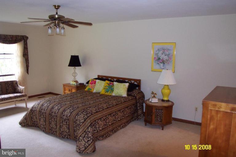 1015 Valewood Road Towson, MD 21286 - Photo 5 of 6 a bedroom with a bed and a chandelier