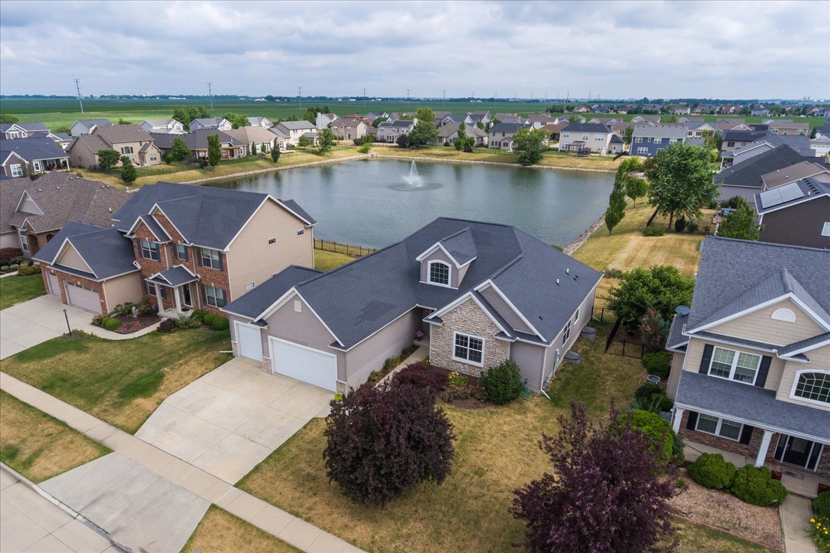 an aerial view of a house with a lake view
