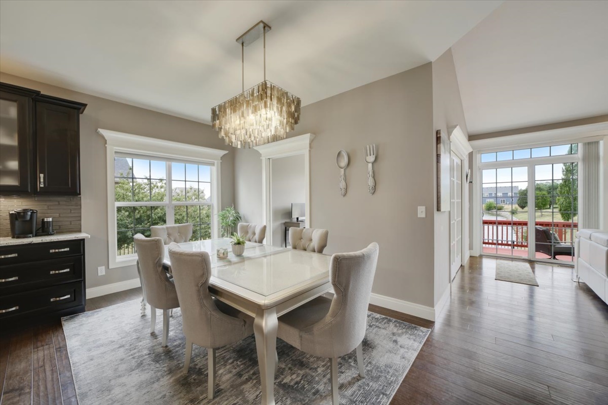 5104 Stonebridge Drive Champaign, IL 61822 - Photo 11 of 69 a view of a dining room with furniture wooden floor and chandelier
