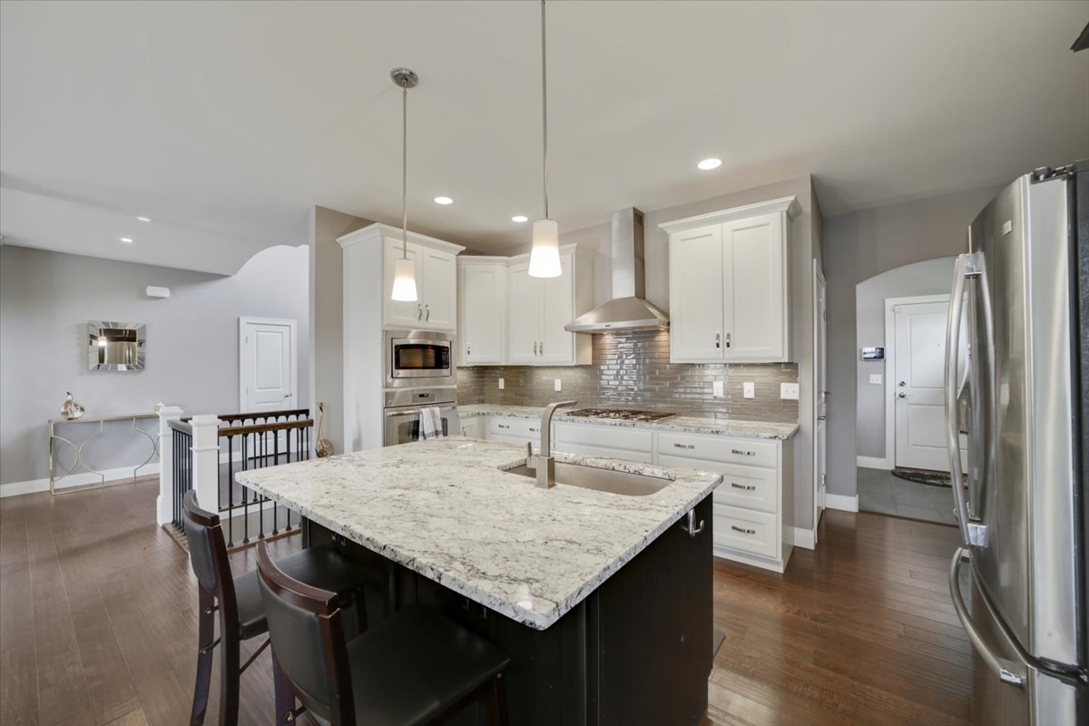 5104 Stonebridge Drive Champaign, IL 61822 - Photo 12 of 69 a kitchen with stainless steel appliances granite countertop a kitchen island a stove a table and chairs