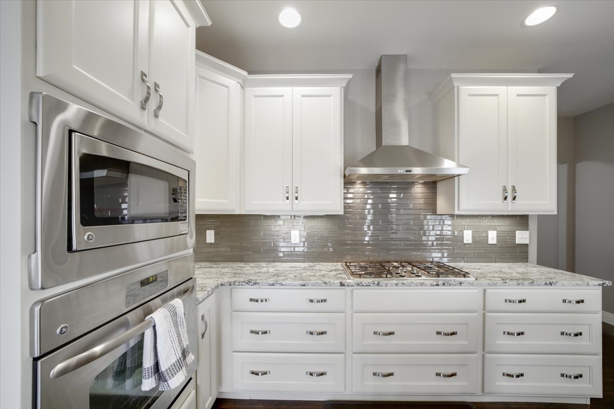 5104 Stonebridge Drive Champaign, IL 61822 - Photo 15 of 69 a kitchen with granite countertop white cabinets and white stainless steel appliances