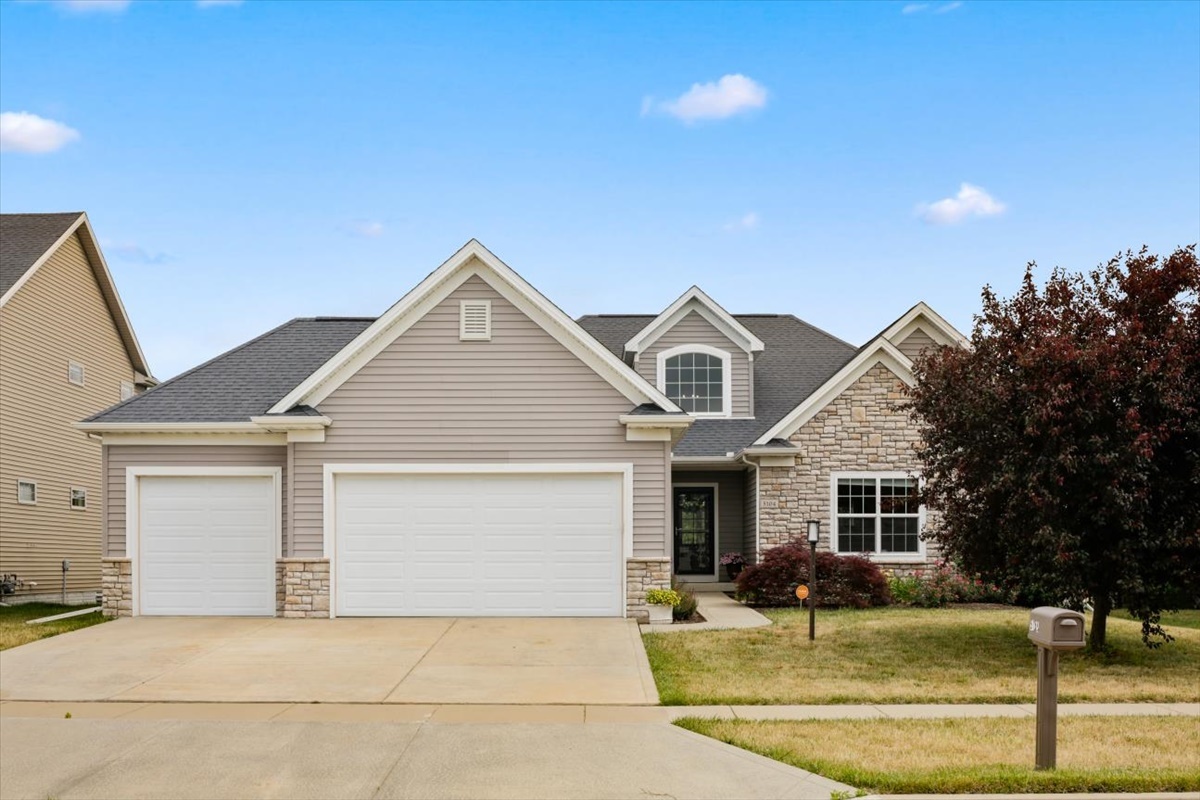 5104 Stonebridge Drive Champaign, IL 61822 - Photo 3 of 69 a front view of a house with swimming pool and a yard