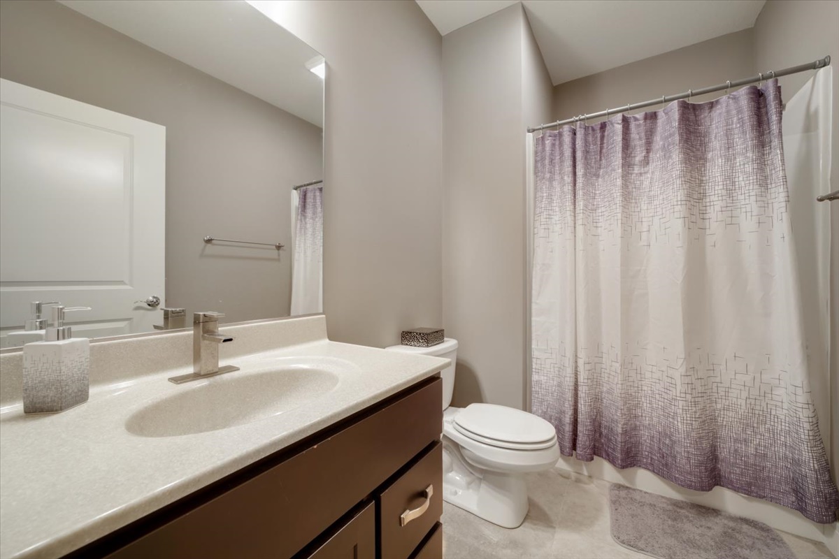5104 Stonebridge Drive Champaign, IL 61822 - Photo 42 of 69 a bathroom with a sink a toilet and shower curtain
