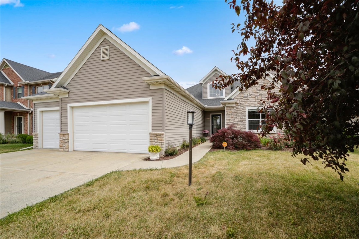 5104 Stonebridge Drive Champaign, IL 61822 - Photo 5 of 69 a view of a house with a yard and garage