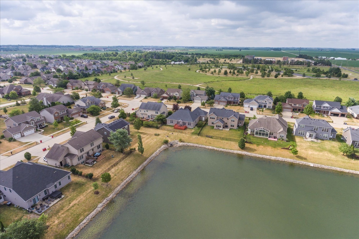 5104 Stonebridge Drive Champaign, IL 61822 - Photo 64 of 69 an aerial view of a house with a lake view