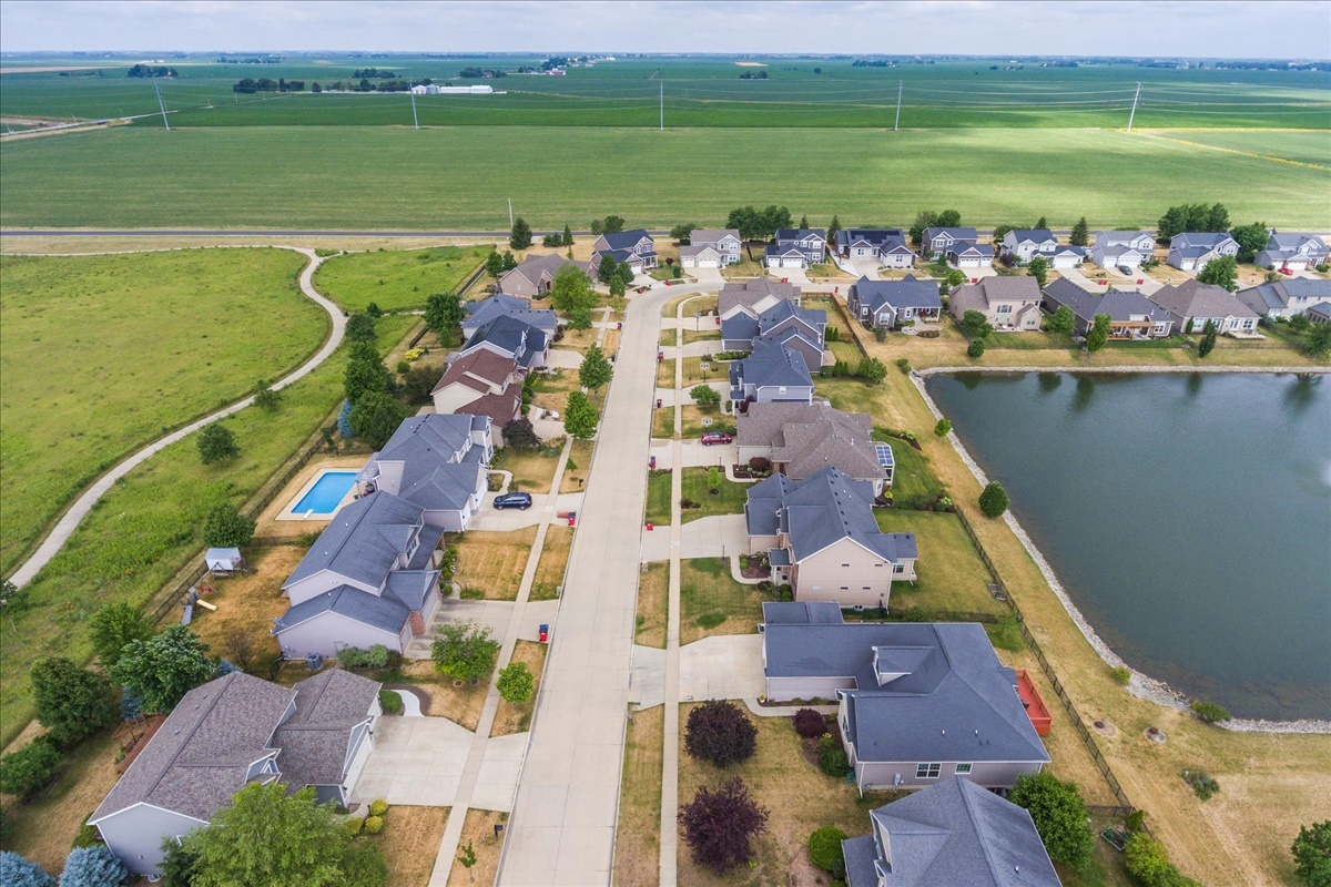 5104 Stonebridge Drive Champaign, IL 61822 - Photo 66 of 69 an aerial view of a house with a lake view
