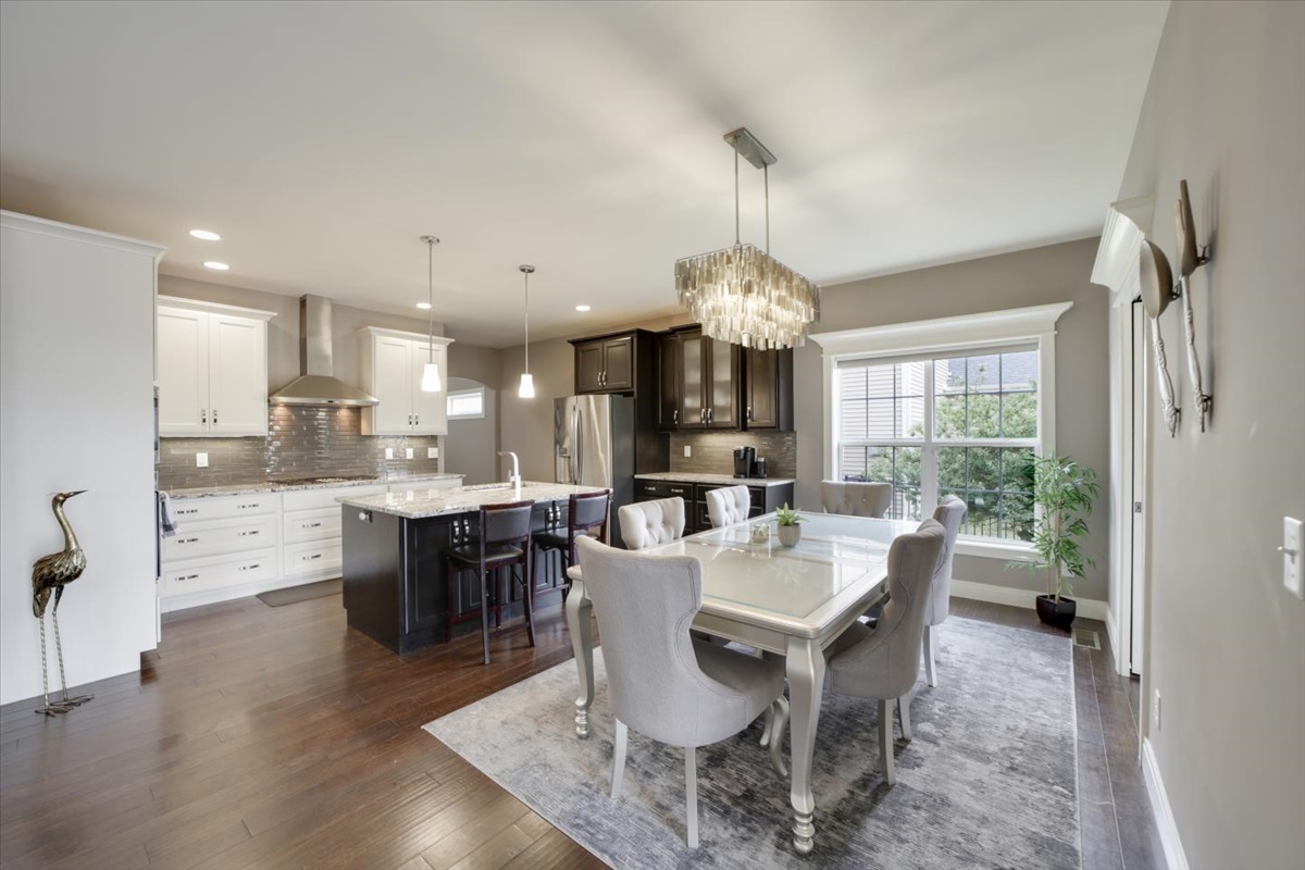 5104 Stonebridge Drive Champaign, IL 61822 - Photo 10 of 69 a view of a dining room with furniture window and wooden floor