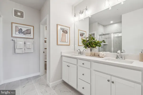 a bathroom with a double vanity sink and a mirror