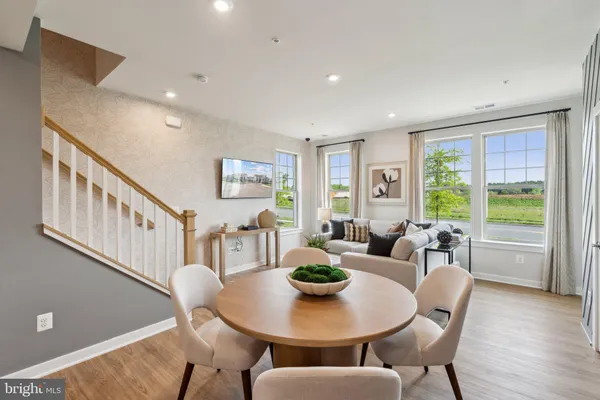 a view of a dining room with furniture window and wooden floor
