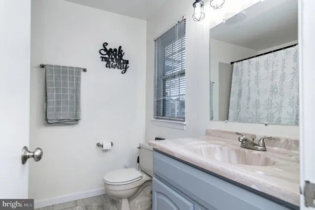 a bathroom with a toilet sink and shower