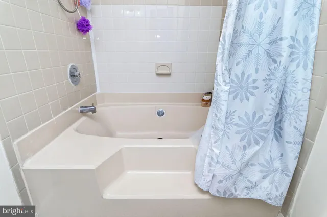 a bathroom with a granite countertop sink toilet and mirror