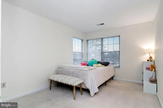 a bedroom with a bed and a wooden floor