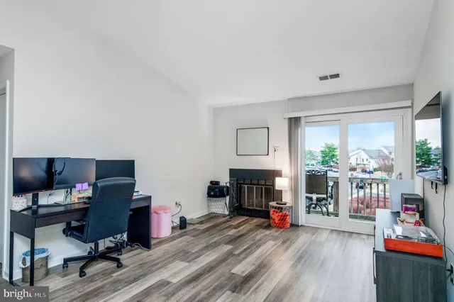 a view of a livingroom with workspace and a window