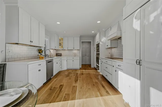 a dining room with furniture a kitchen view and a chandelier