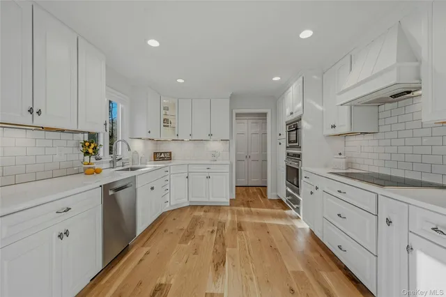 a kitchen with a dining table chairs and view of living room