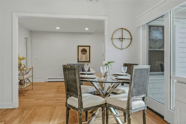a view of a dining room with furniture and a potted plant