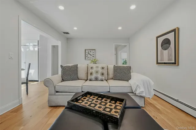 a bedroom with a bed and painting on the wall
