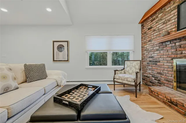a spacious bedroom with a bed and a painting on the wall