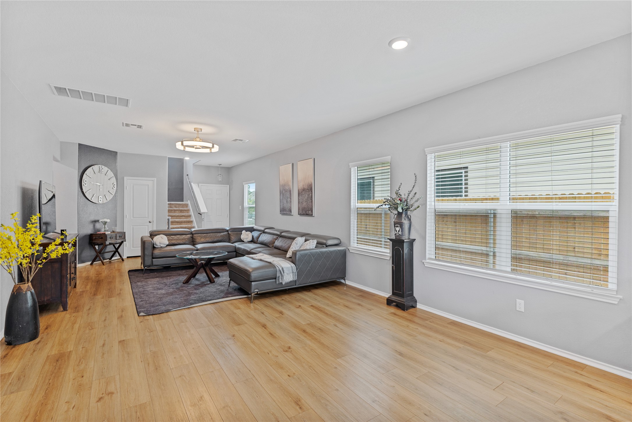 425 Perfect World Loop Jarrell, TX 76537 - Photo 7 of 29 Open-concept living space with wood-finish flooring, recessed lighting, and multiple windows