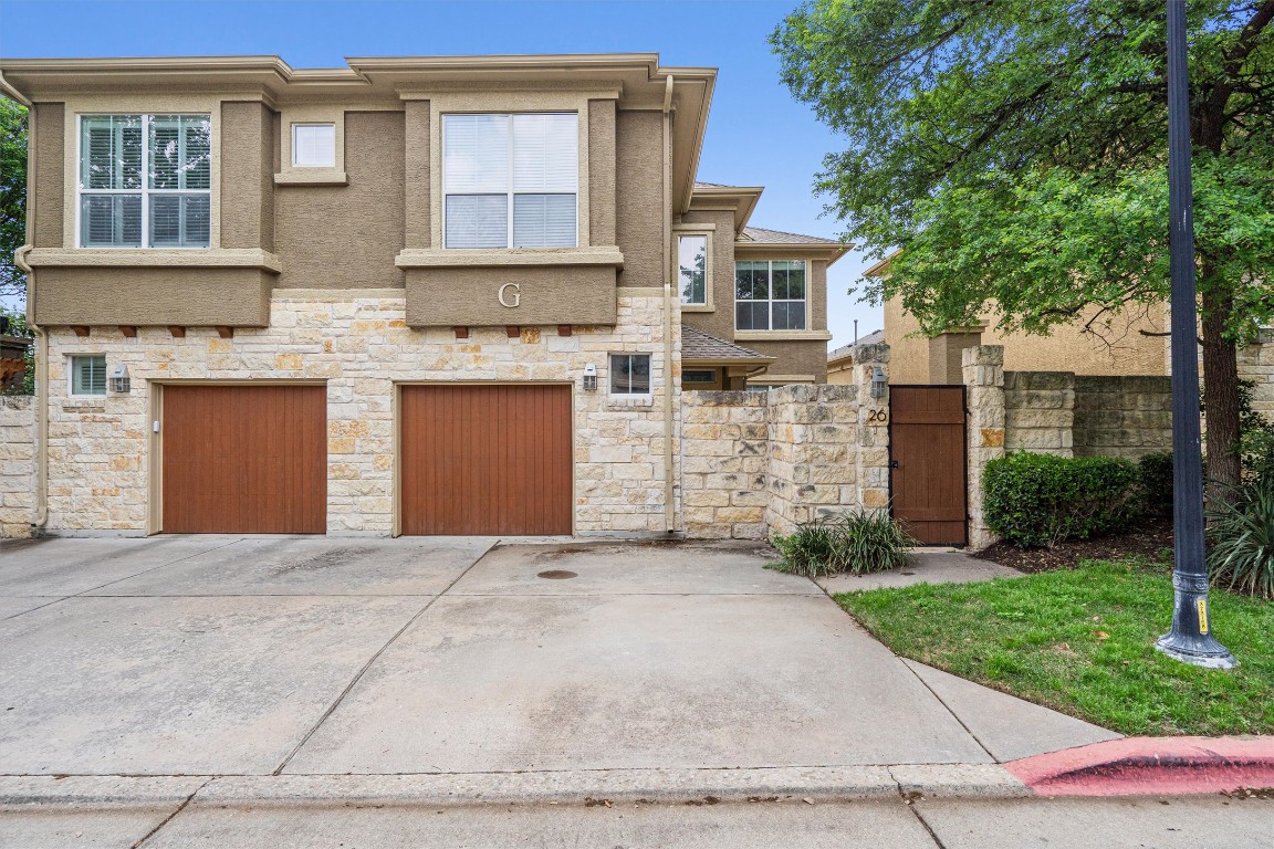 a front view of a house with a yard and garage