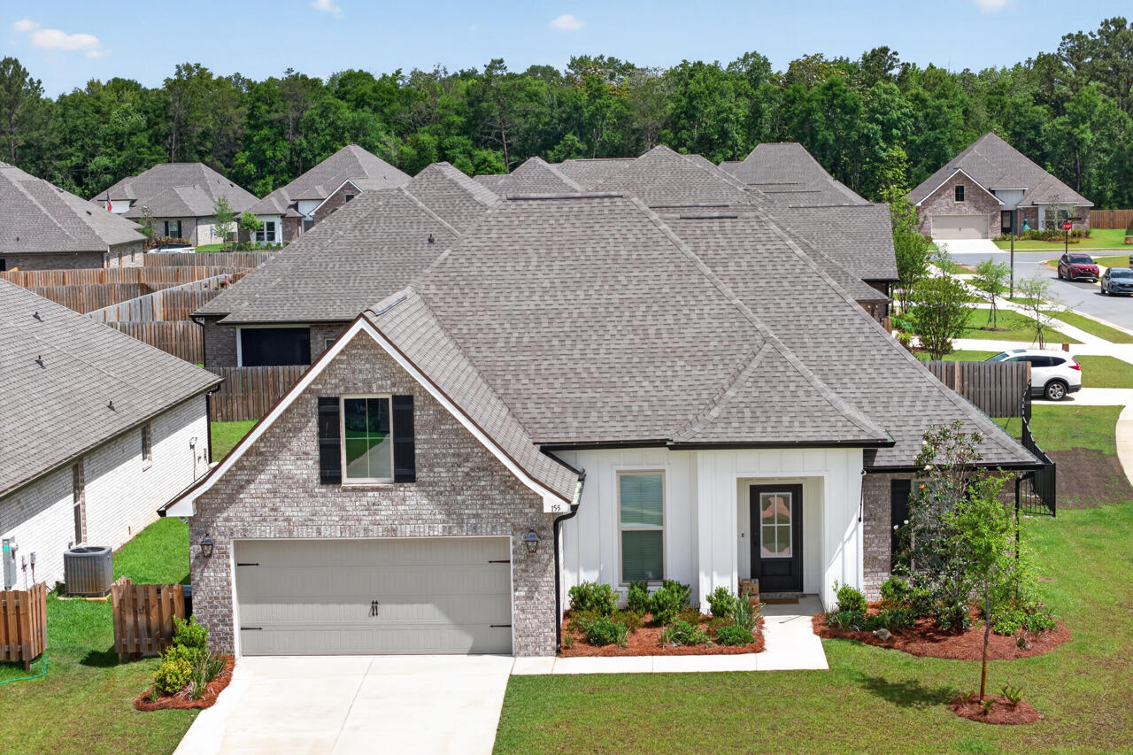 a aerial view of a house with a yard and potted plants
