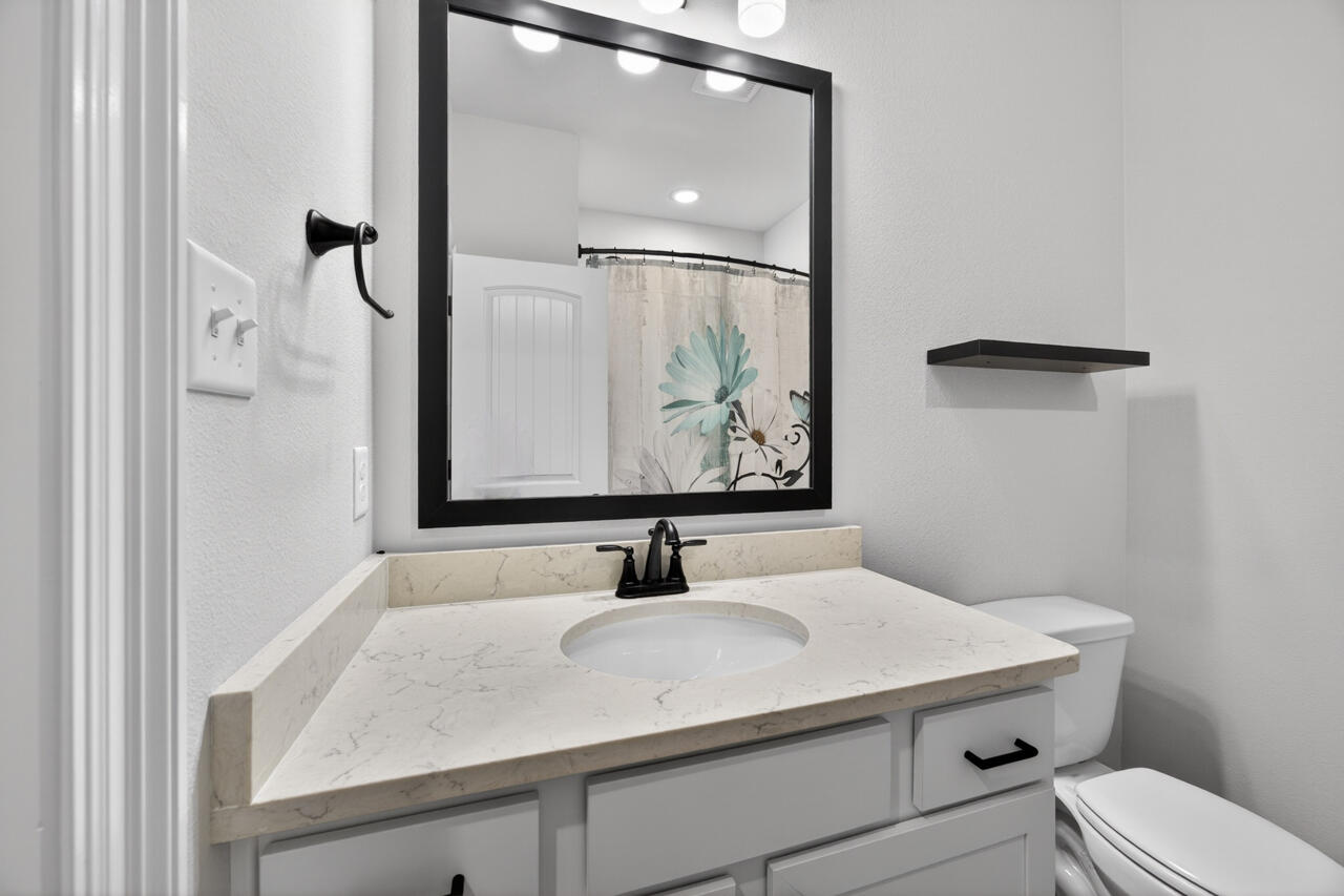 155 Lumen Loop Freeport, FL 32439 - Photo 28 of 48 a bathroom with a sink and a mirror