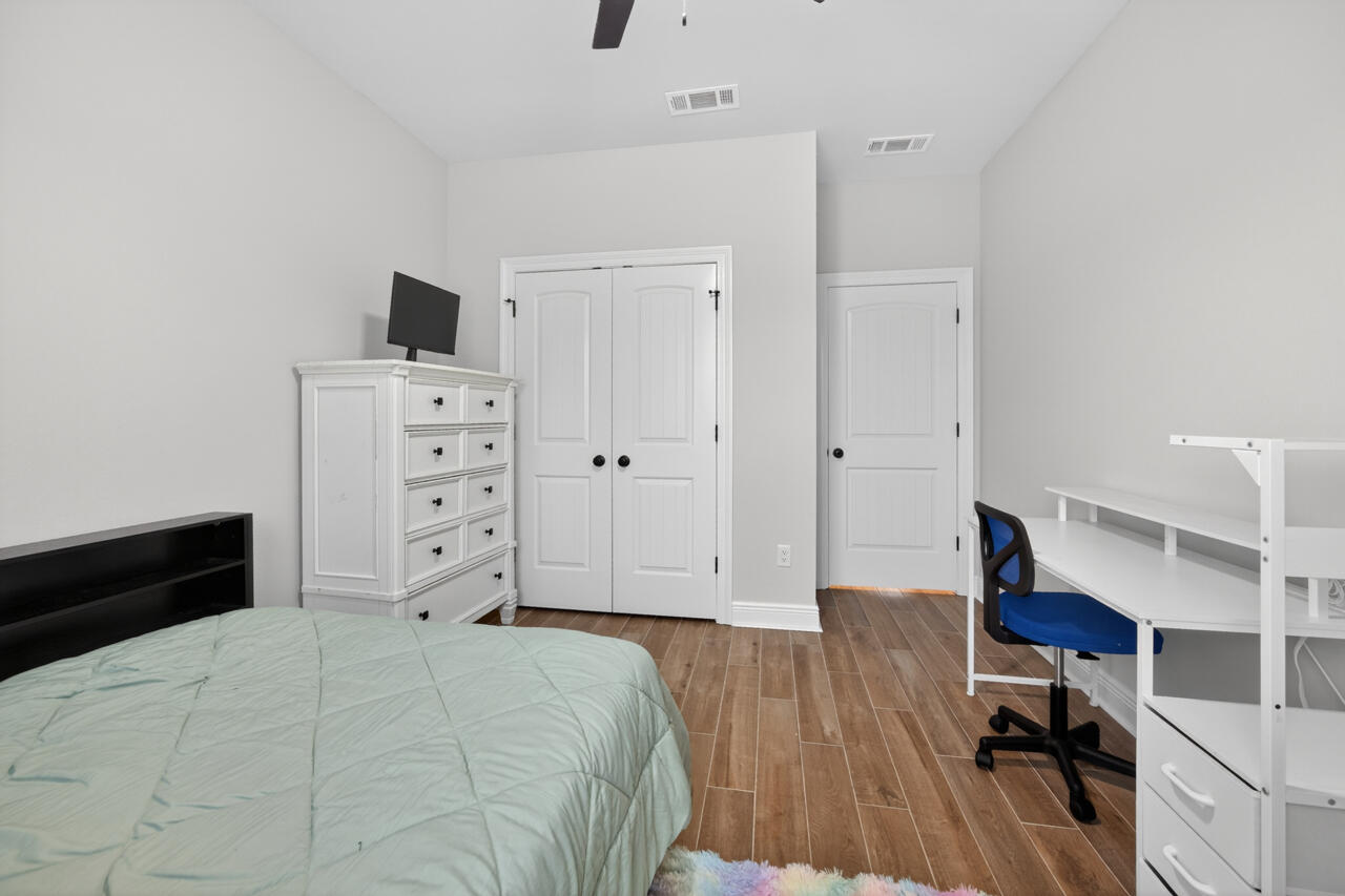 155 Lumen Loop Freeport, FL 32439 - Photo 29 of 46 a bedroom with a bed and a tv
