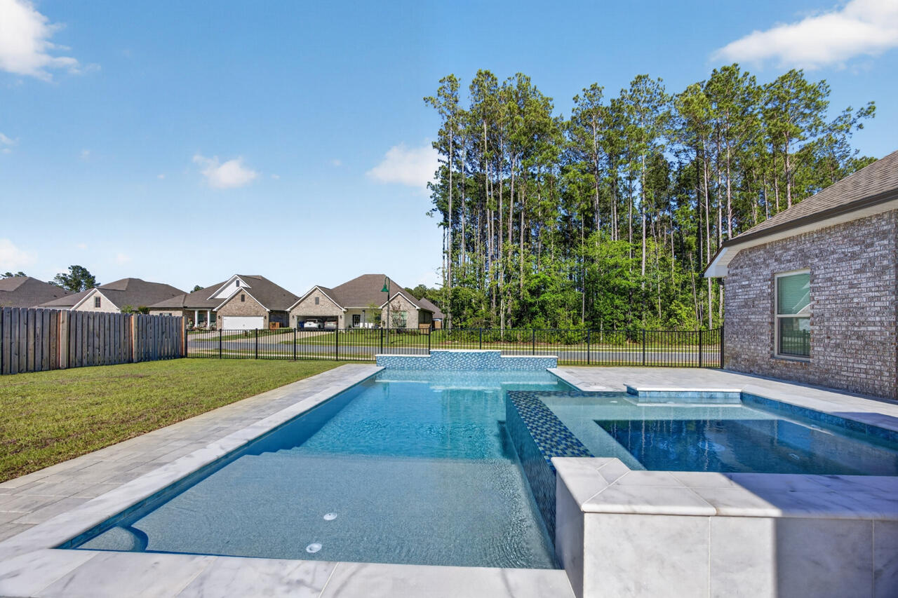 155 Lumen Loop Freeport, FL 32439 - Photo 35 of 46 a view of an house with backyard space and garden