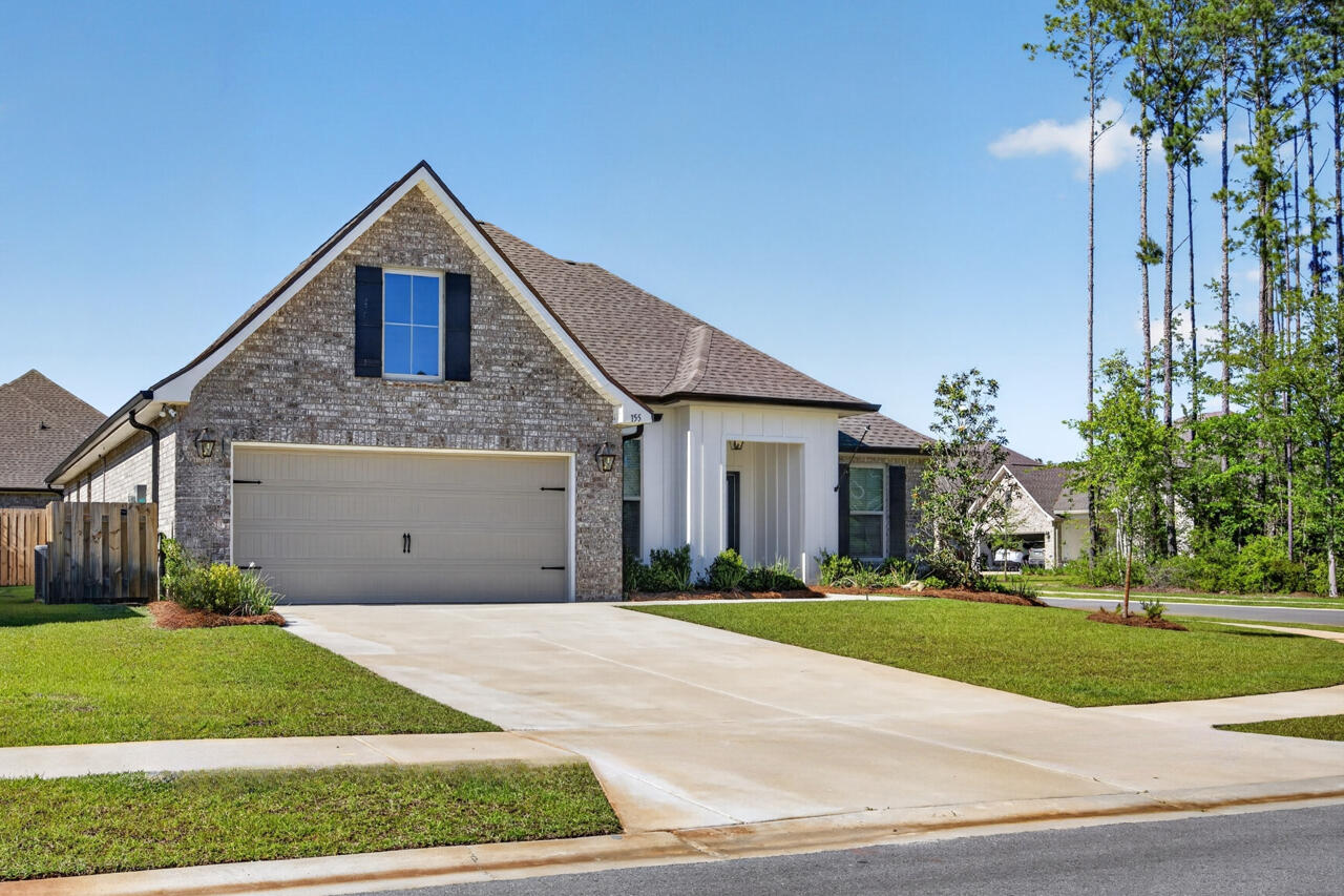 155 Lumen Loop Freeport, FL 32439 - Photo 44 of 46 a front view of a house with a yard and garage