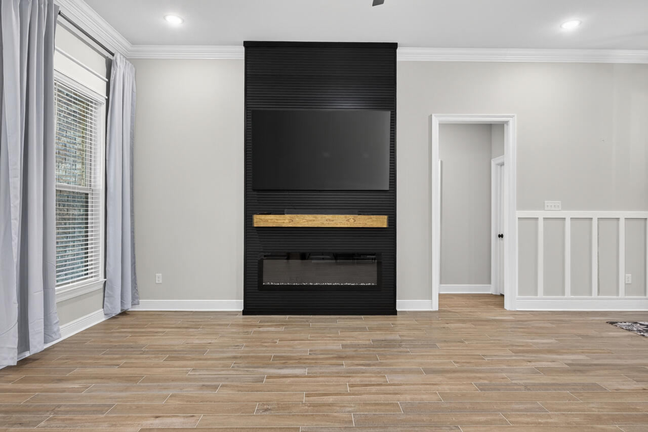 155 Lumen Loop Freeport, FL 32439 - Photo 6 of 46 a view of an empty room with a fireplace and a window