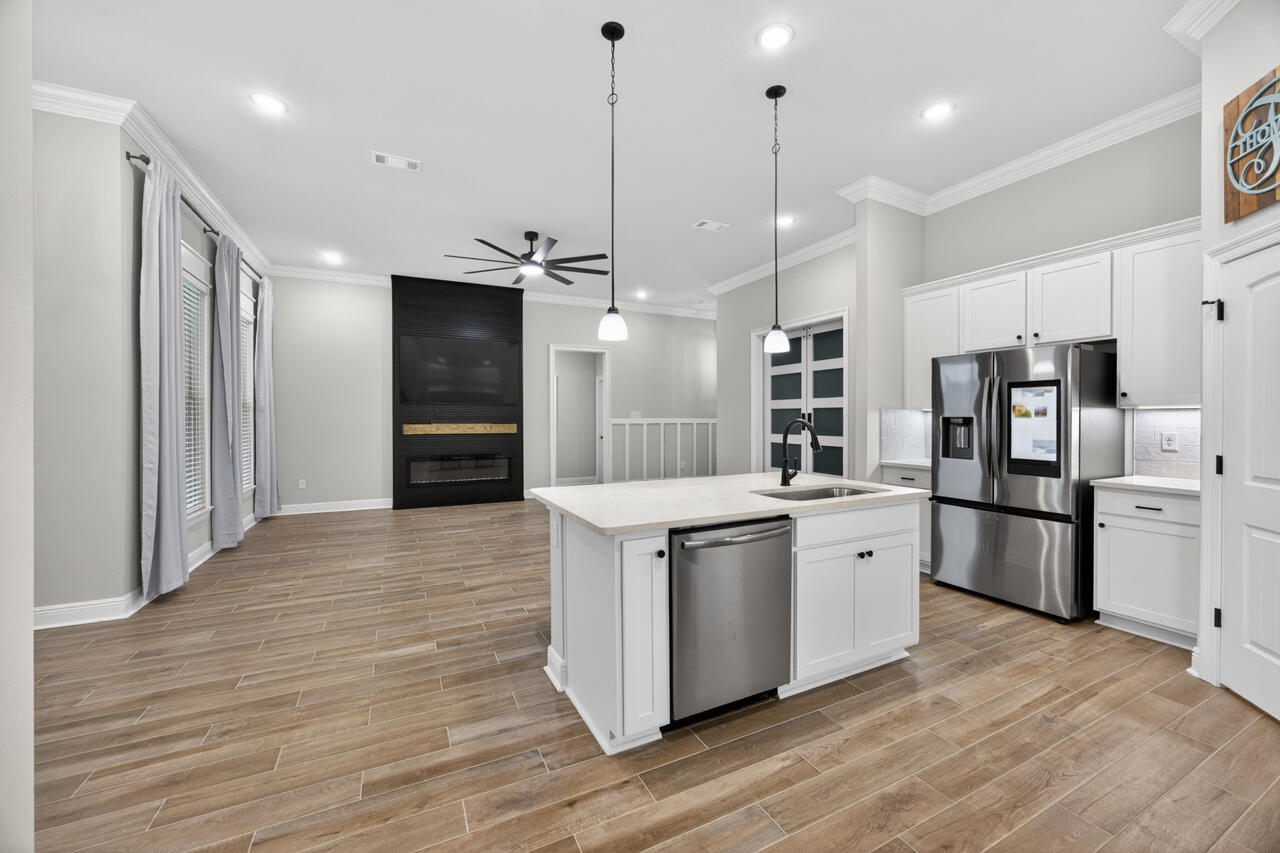 155 Lumen Loop Freeport, FL 32439 - Photo 10 of 48 a kitchen with stainless steel appliances granite countertop a refrigerator a sink and a stove