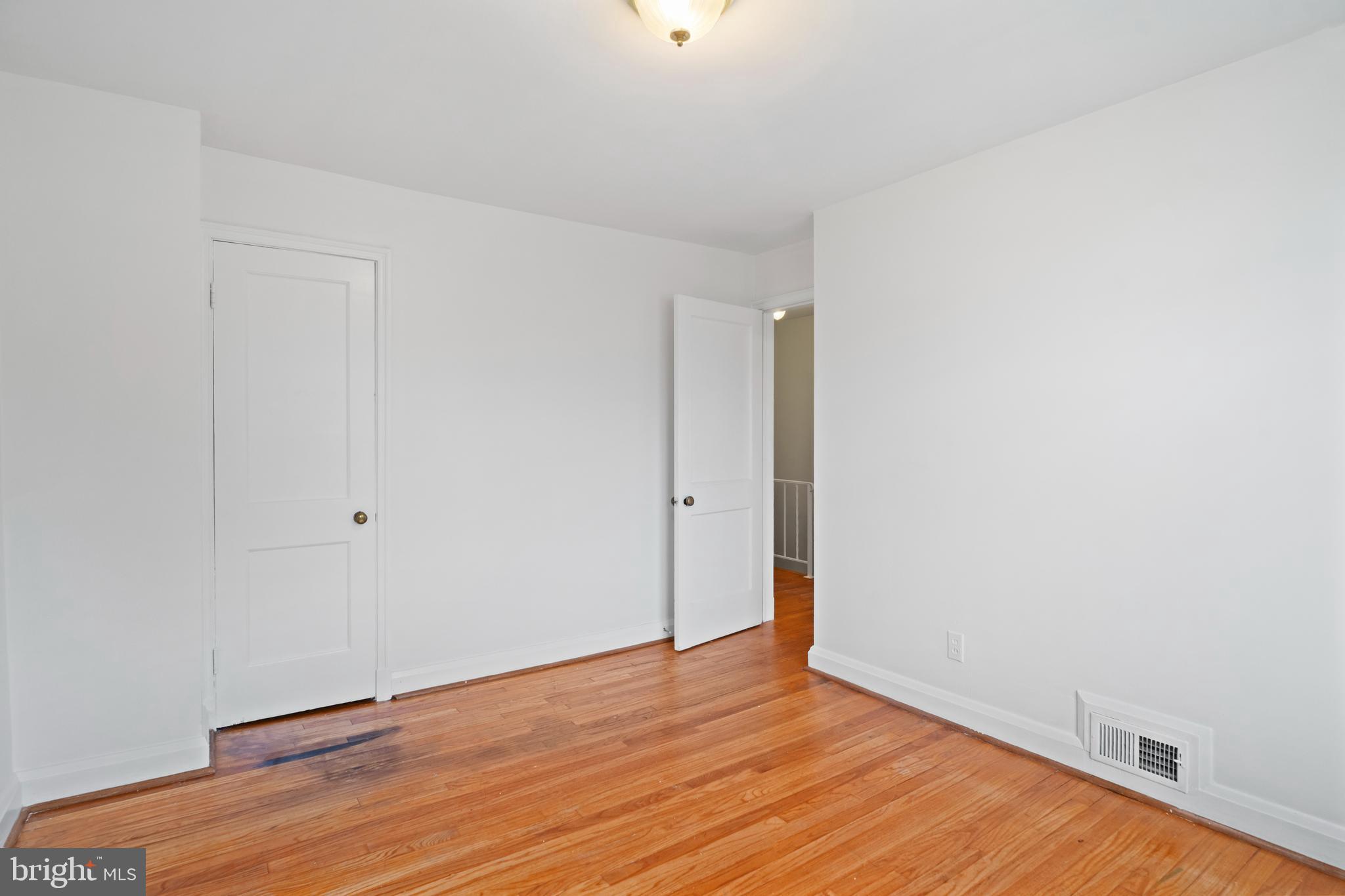 840 Evesham Avenue Baltimore, MD 21212 - Photo 14 of 20 a view of an empty room with wooden floor
