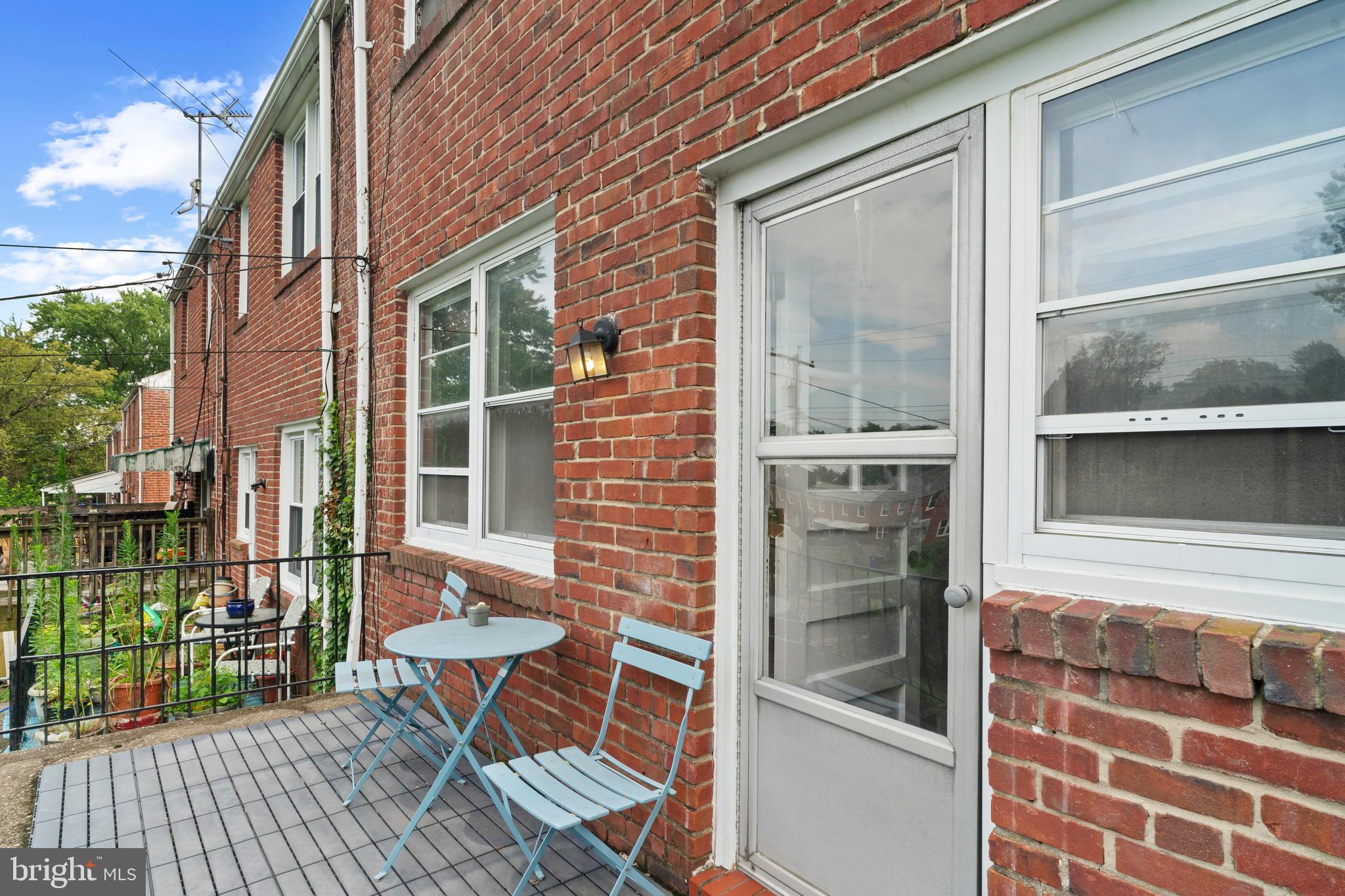 840 Evesham Avenue Baltimore, MD 21212 - Photo 18 of 20 a view of a balcony with chairs and a potted plant