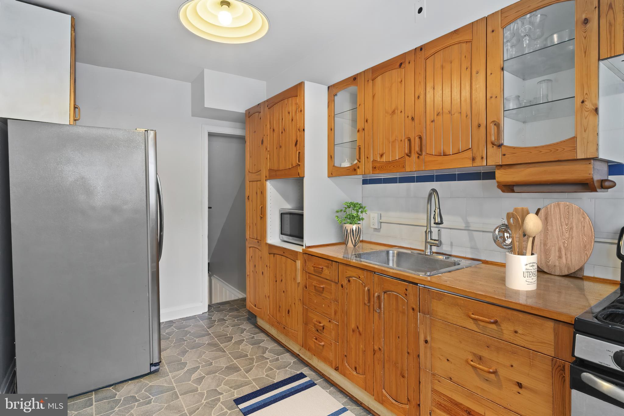 840 Evesham Avenue Baltimore, MD 21212 - Photo 10 of 20 a kitchen with stainless steel appliances granite countertop a refrigerator and a sink