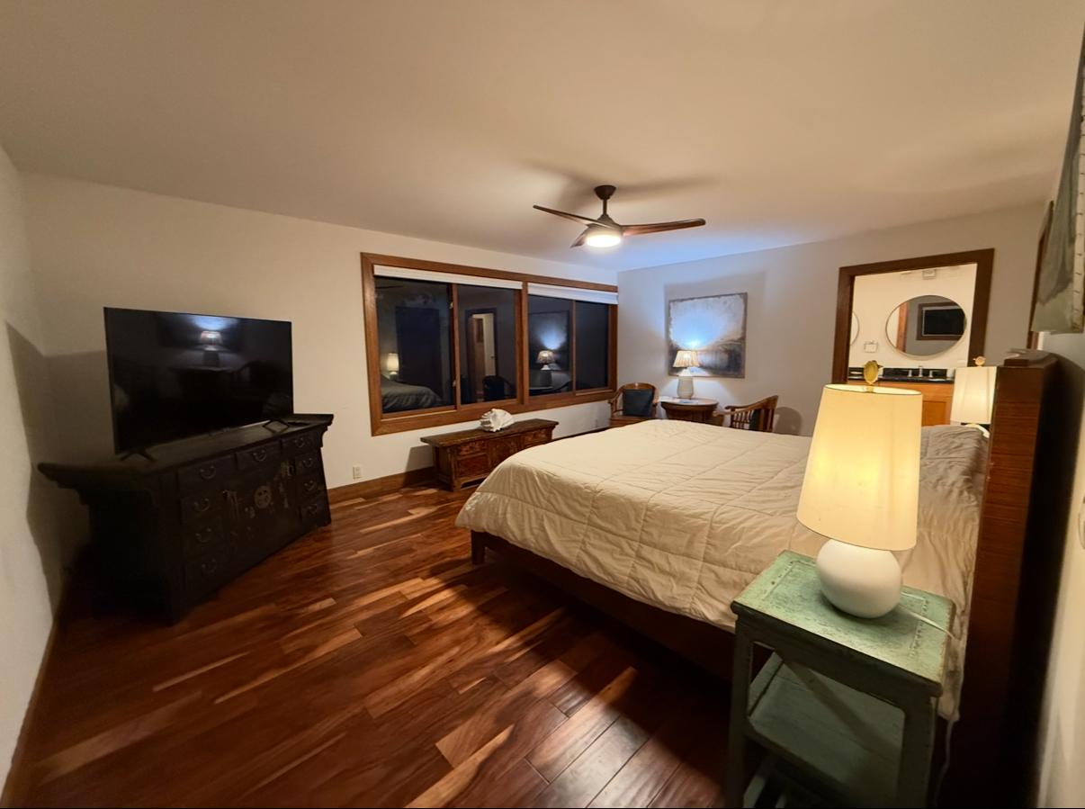 48-5528 Waipio Valley Road Honokaa, HI 96727 - Photo 15 of 18 a bedroom with a bed and wooden floor
