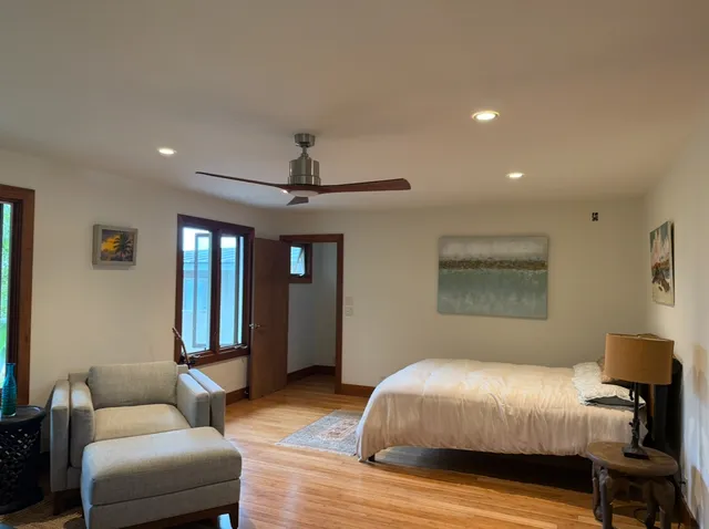 a bedroom with furniture and wooden floor