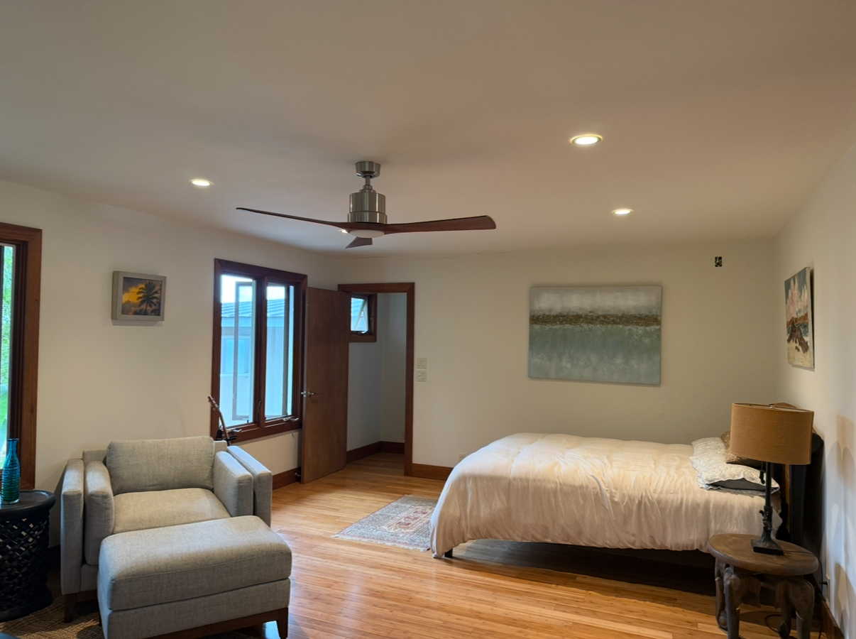48-5528 Waipio Valley Road Honokaa, HI 96727 - Photo 18 of 18 a bedroom with furniture and wooden floor
